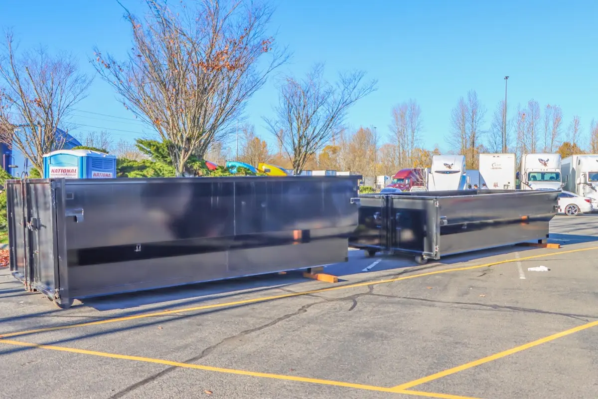 Professional dumpster rental service with roll-off container on residential driveway in Taylorsville